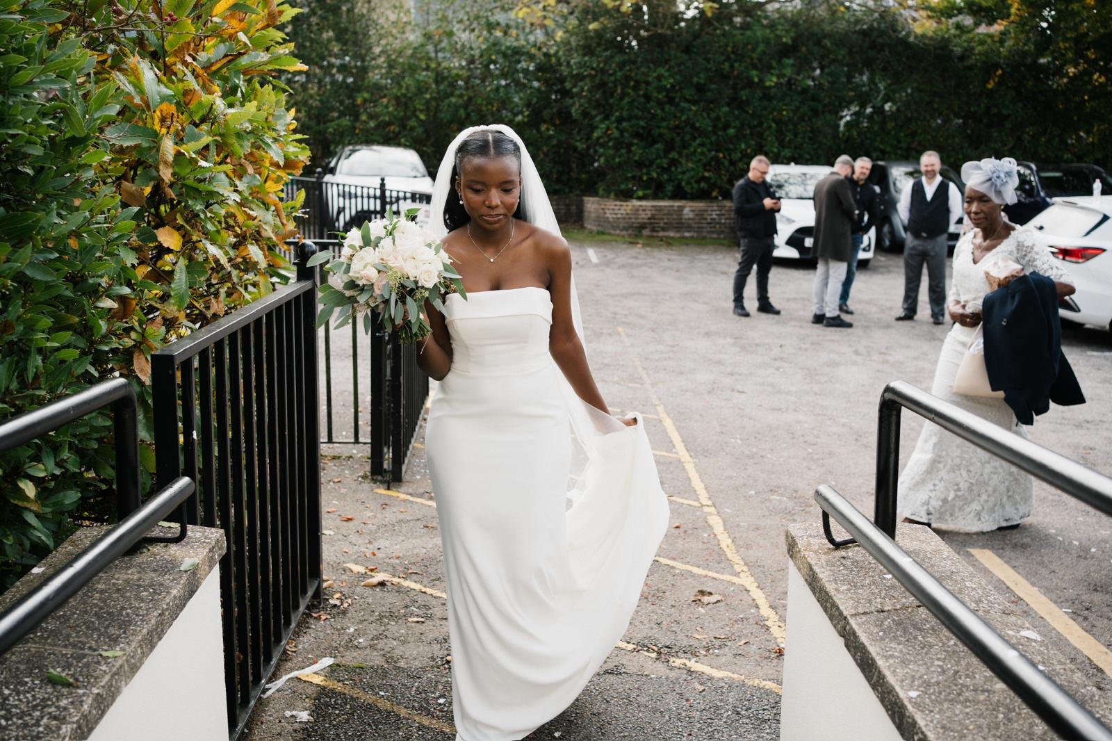 Sandra arriving in the dress with bouquet and veil