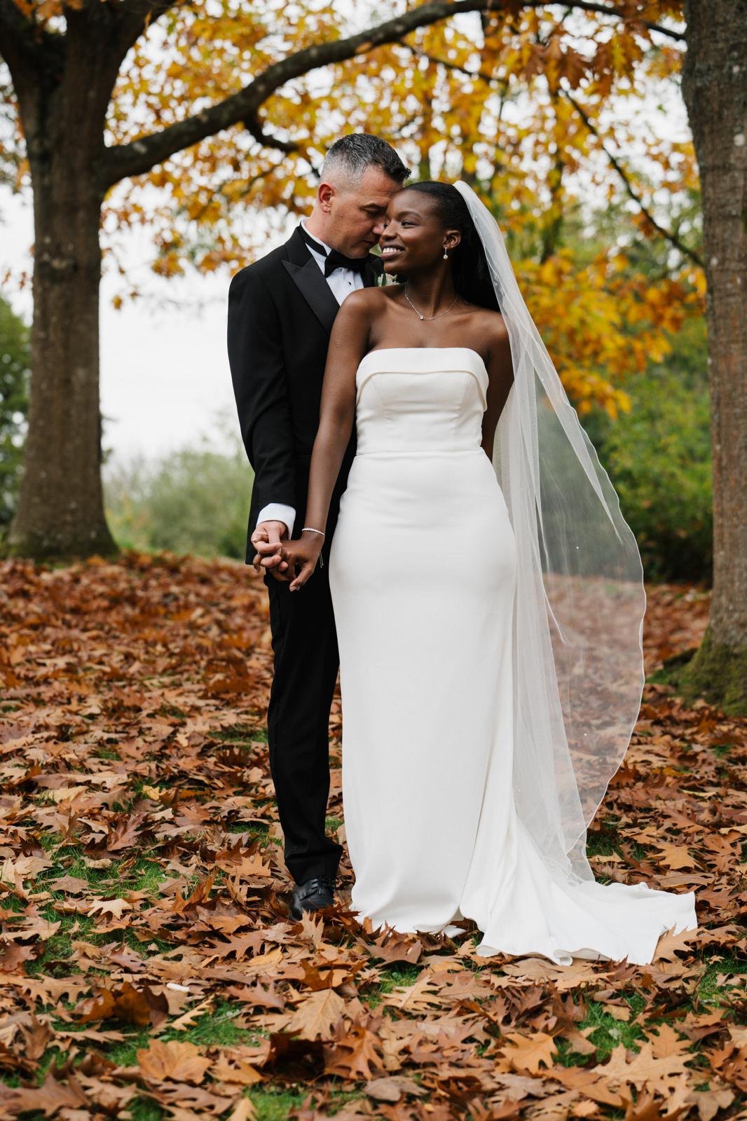 Sandra and Ciprian photographed outdoors with the dress shown full length